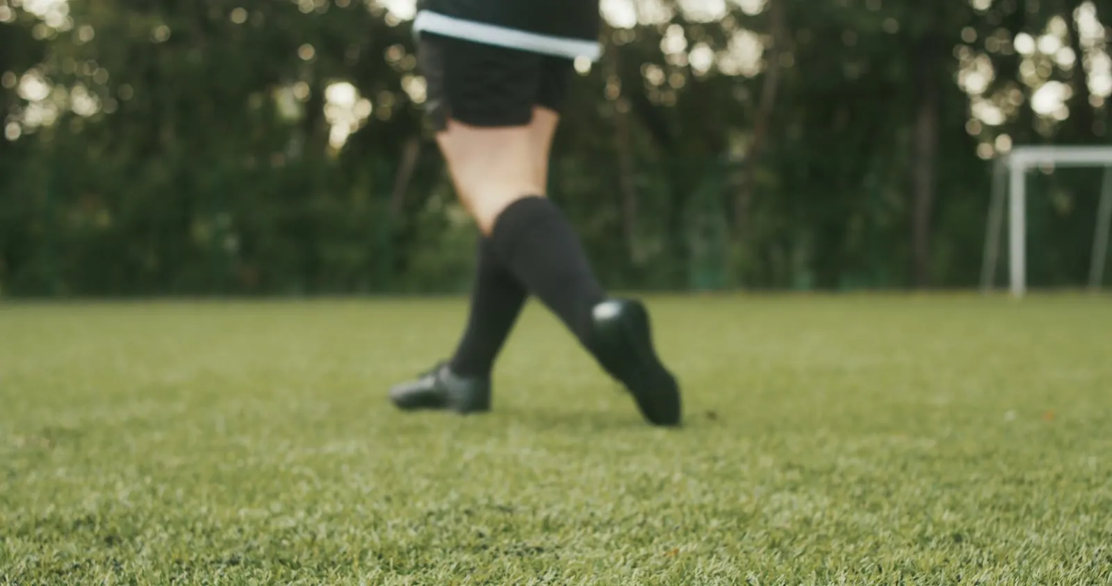 Player's boots and socks on a grass pitch