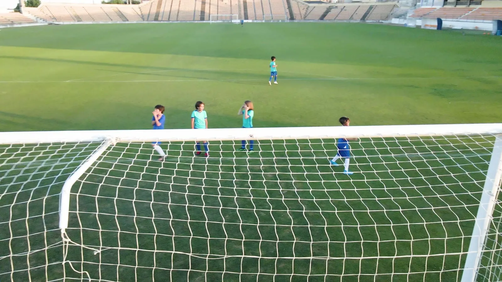 Young players taking shots on goal during a training session