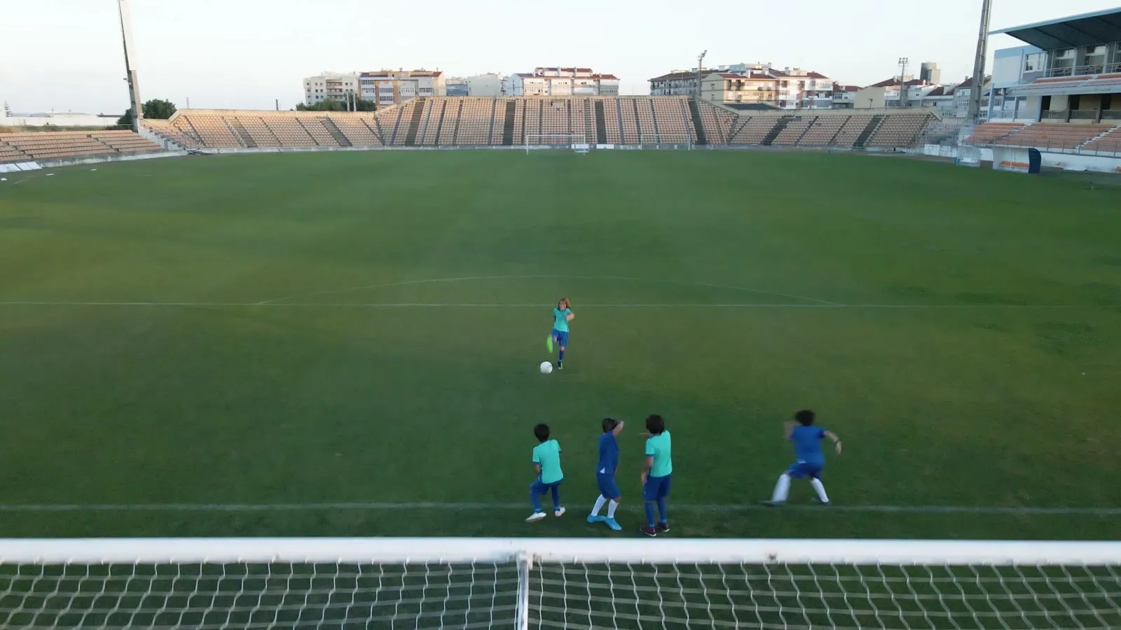 Young players in a match on a full-size pitch